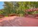 Spacious red deck featuring a hot tub and a pergola, perfect for outdoor relaxation and entertaining at 3866 Teresa Sw Ter, Lilburn, GA 30047