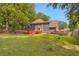 Exterior view of the home with a deck and a large grassy backyard at 3866 Teresa Sw Ter, Lilburn, GA 30047