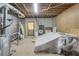 View of unfinished basement area with concrete floor, door, and equipment at 3866 Teresa Sw Ter, Lilburn, GA 30047
