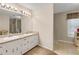 Bathroom featuring a double sink vanity, carpeted floor, and a separate shower at 3866 Teresa Sw Ter, Lilburn, GA 30047