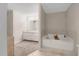 Bathroom featuring a double vanity and a large soaking tub with tile floor at 3866 Teresa Sw Ter, Lilburn, GA 30047