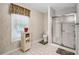 Bathroom with shower and toilet, and window with blinds and cabinet at 3866 Teresa Sw Ter, Lilburn, GA 30047