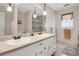 Well-lit bathroom with a double vanity, large mirror, and neutral finishes, providing a clean and functional space at 3866 Teresa Sw Ter, Lilburn, GA 30047