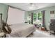 Comfortable bedroom with a ceiling fan, a large window, and a neutral color scheme, offering a serene atmosphere at 3866 Teresa Sw Ter, Lilburn, GA 30047