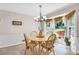 Inviting dining area with natural light, a charming chandelier, and views of the outdoor space at 3866 Teresa Sw Ter, Lilburn, GA 30047