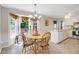 Bright dining area features a classic chandelier, large windows, and a cozy breakfast table at 3866 Teresa Sw Ter, Lilburn, GA 30047