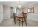 Elegant dining room featuring a decorative chandelier, a beautiful wood table with seating for six, and neutral wall colors at 3866 Teresa Sw Ter, Lilburn, GA 30047