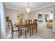 Elegant dining room featuring a decorative chandelier, a beautiful wood table with seating for six, and neutral wall colors at 3866 Teresa Sw Ter, Lilburn, GA 30047