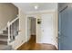 Inviting foyer with hardwood floors, staircase with white railing, and neutral wall colors creating a bright, welcoming space at 3866 Teresa Sw Ter, Lilburn, GA 30047