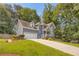 Two-story home with a well-manicured lawn, attractive landscaping, and a long driveway leading to a two-car garage at 3866 Teresa Sw Ter, Lilburn, GA 30047