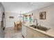 Eat-in kitchen offers stainless appliances, white cabinetry, and a view of the backyard at 3866 Teresa Sw Ter, Lilburn, GA 30047