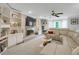 Bright living room featuring custom built-in shelving, a cozy fireplace, and a large, comfortable sectional sofa at 3866 Teresa Sw Ter, Lilburn, GA 30047