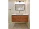 Modern bathroom with floating wood vanity, quartz countertop, and geometric tiled floor at 5023 Rockborough Trl, Norcross, GA 30071