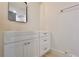 Bathroom featuring white vanity with storage drawers, a black framed mirror, and neutral colored walls at 5023 Rockborough Trl, Norcross, GA 30071