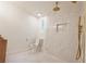 This bathroom features marble tiled shower with gold hardware and a niche, along with matching floor tiles at 5023 Rockborough Trl, Norcross, GA 30071