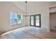 Bright dining area with French doors and modern chandelier, perfect for Gathering meals at 5023 Rockborough Trl, Norcross, GA 30071