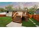 Back of house featuring a wooden deck with stairs in a grassy yard at 5023 Rockborough Trl, Norcross, GA 30071