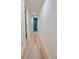 Hallway with luxury vinyl plank flooring leading to rooms with blue painted doors at 5023 Rockborough Trl, Norcross, GA 30071