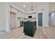 Modern kitchen with white cabinets, stainless steel appliances, a sleek island, and stylish pendant lighting at 5023 Rockborough Trl, Norcross, GA 30071