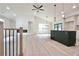 Open-concept living space featuring hardwood floors, pendant lights, and a kitchen island at 5023 Rockborough Trl, Norcross, GA 30071