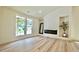 Bright living room featuring a modern fireplace and large windows at 5023 Rockborough Trl, Norcross, GA 30071