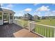Wooden porch with white railings looking onto the grassy community behind the house at 92 River Walk Pkwy, Euharlee, GA 30145