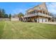 Expansive backyard featuring a well-maintained lawn and a view of the house with deck and screened porch at 92 River Walk Pkwy, Euharlee, GA 30145