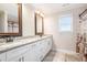 Bathroom featuring double sink vanity, granite countertop, brushed nickel faucets and a large window at 92 River Walk Pkwy, Euharlee, GA 30145