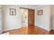 Bedroom with hardwood floors and a decorative sliding barn door leading to the Primary bathroom at 92 River Walk Pkwy, Euharlee, GA 30145