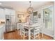 Bright dining area featuring a modern light fixture, wood floors, and large windows for natural light at 92 River Walk Pkwy, Euharlee, GA 30145