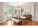 Bright dining room featuring a modern chandelier, a large table, and plenty of natural light at 92 River Walk Pkwy, Euharlee, GA 30145