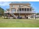 Back of house showing the deck and screened porch with steps down to the yard at 92 River Walk Pkwy, Euharlee, GA 30145