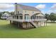 Back of home featuring a spacious porch and staircase to the yard at 92 River Walk Pkwy, Euharlee, GA 30145