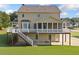 Home's rear view highlighting a spacious porch and access to the backyard at 92 River Walk Pkwy, Euharlee, GA 30145
