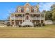Charming two-story home with a welcoming front porch and beautiful stone and siding details at 92 River Walk Pkwy, Euharlee, GA 30145