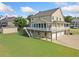 Rear view of the house showcasing a spacious porch and a three-car garage at 92 River Walk Pkwy, Euharlee, GA 30145