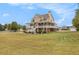 Spacious two-story home with wrap around porch, brick foundation, and expansive front yard at 92 River Walk Pkwy, Euharlee, GA 30145