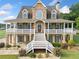 Stunning home featuring a stone facade and inviting wraparound porch, offering a blend of elegance and charm at 92 River Walk Pkwy, Euharlee, GA 30145