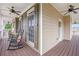 Covered front porch boasts wooden flooring, ceiling fans, rocking chairs, and exterior siding at 92 River Walk Pkwy, Euharlee, GA 30145