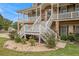 Well-manicured lawn with tasteful landscaping details leading up to the inviting front steps at 92 River Walk Pkwy, Euharlee, GA 30145