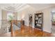 Hallway features hardwood floors, natural light, and a staircase leading to lower level at 92 River Walk Pkwy, Euharlee, GA 30145