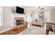 Inviting living room with a brick fireplace, hardwood floors, and comfortable seating arrangement at 92 River Walk Pkwy, Euharlee, GA 30145
