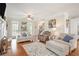 Cozy living room featuring hardwood floors, neutral decor, and an abundance of natural light at 92 River Walk Pkwy, Euharlee, GA 30145