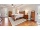 Bedroom with tray ceiling, hardwood floors, and ample natural light from multiple windows at 92 River Walk Pkwy, Euharlee, GA 30145