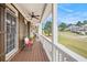 Back porch features plank flooring, ceiling fans, and bright white railings at 92 River Walk Pkwy, Euharlee, GA 30145
