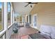 Cozy screened-in porch with comfortable seating and views of the backyard and outdoor cooking area at 92 River Walk Pkwy, Euharlee, GA 30145