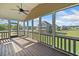 Inviting screened-in porch with a ceiling fan and a peaceful view of the expansive community at 92 River Walk Pkwy, Euharlee, GA 30145