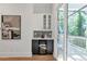 Modern bar area with wine cooler, black and white backsplash, and access to balcony at 1464 Ezra Church Nw Dr, Atlanta, GA 30314