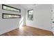An empty bedroom with light hardwood floors and multiple black trimmed windows at 1464 Ezra Church Nw Dr, Atlanta, GA 30314