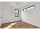 Bedroom features hardwood flooring, white walls, and horizontal windows at 1464 Ezra Church Nw Dr, Atlanta, GA 30314